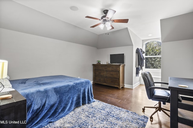 bedroom featuring lofted ceiling, wood finished floors, a ceiling fan, and baseboards