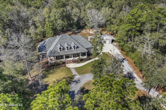 birds eye view of property with a wooded view