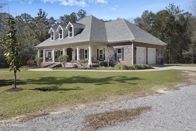 view of front of house with a garage, roof with shingles, covered porch, a front lawn, and brick siding