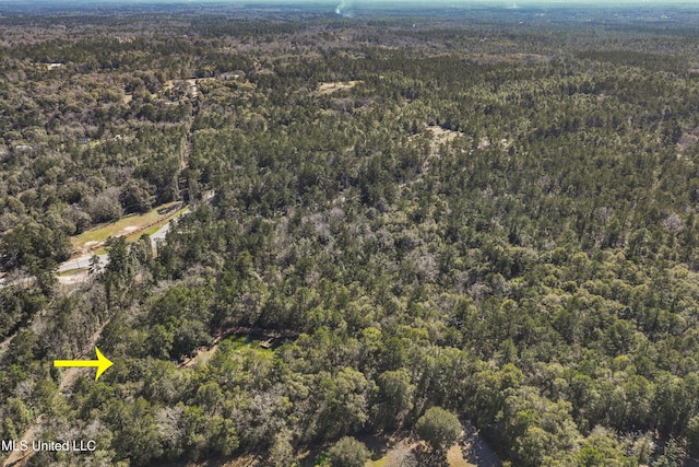 drone / aerial view with a view of trees