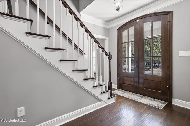 foyer featuring ornamental molding, french doors, wood finished floors, and baseboards