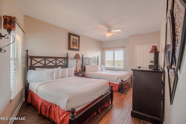 2230 Beach Dr Unit 808, Gulfport, MS 39507 - bedroom featuring baseboards, ceiling fan, fridge, and dark wood-type flooring