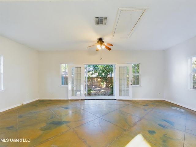 tiled spare room featuring french doors, a wealth of natural light, and ceiling fan