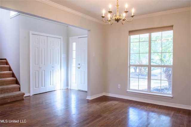 entryway featuring a notable chandelier, dark hardwood / wood-style floors, and ornamental molding