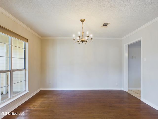 empty room featuring wood-type flooring, a textured ceiling, an inviting chandelier, and crown molding