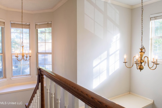 hall featuring crown molding and a notable chandelier