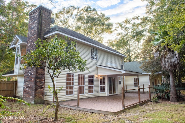 back of house with a wooden deck