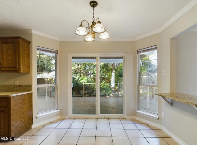 unfurnished dining area featuring light tile patterned flooring, crown molding, and a wealth of natural light