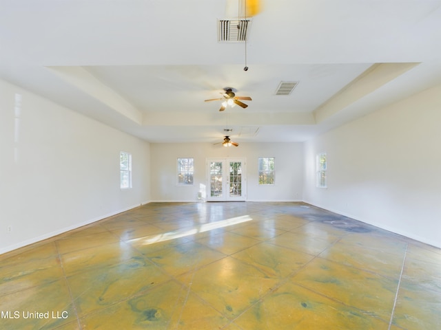 unfurnished room with ceiling fan, french doors, and a tray ceiling