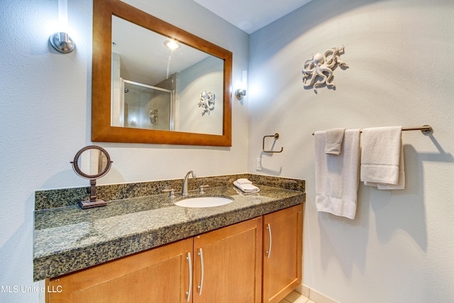 full bathroom with a shower stall and vanity