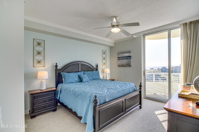 bedroom with expansive windows, a ceiling fan, light carpet, a textured ceiling, and access to outside