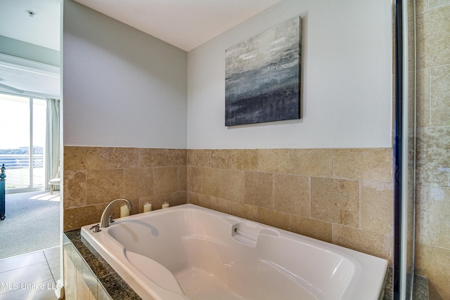 bathroom featuring tile patterned flooring and a bath