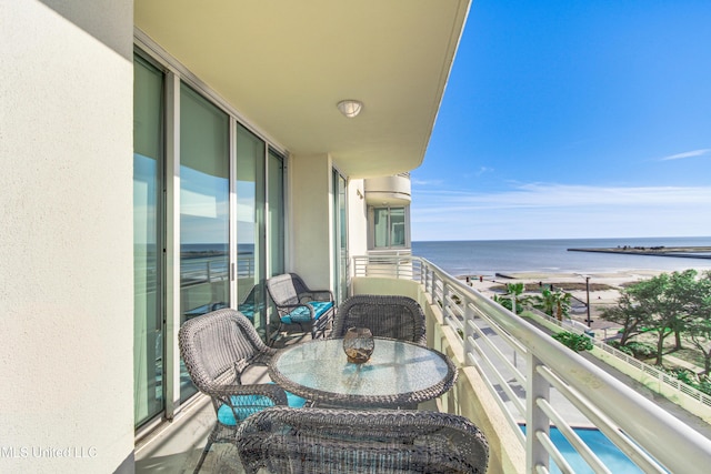 balcony with a beach view and a water view