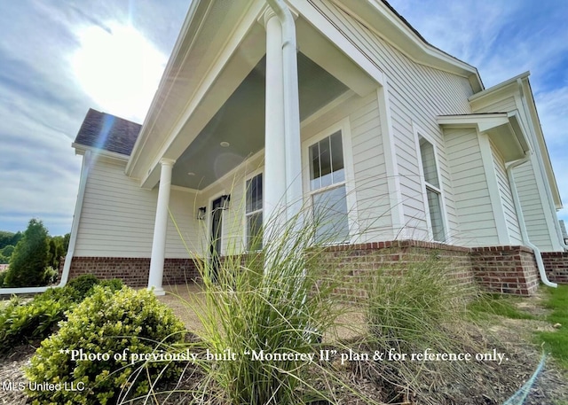 view of property exterior with covered porch