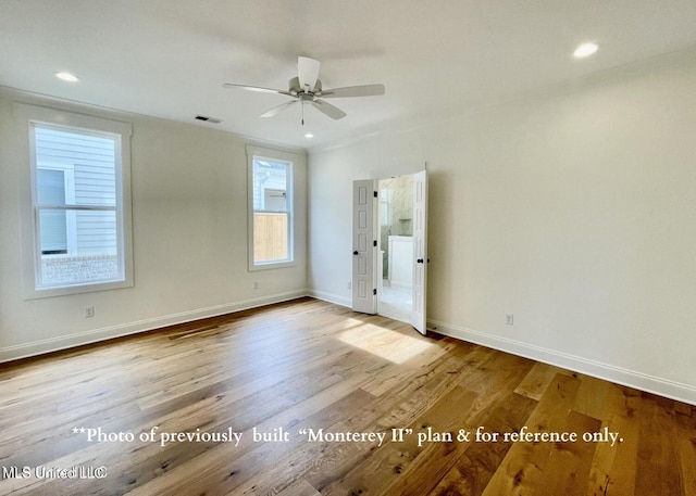 empty room with light hardwood / wood-style floors and ceiling fan