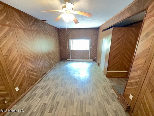 unfurnished room with a ceiling fan and light wood finished floors