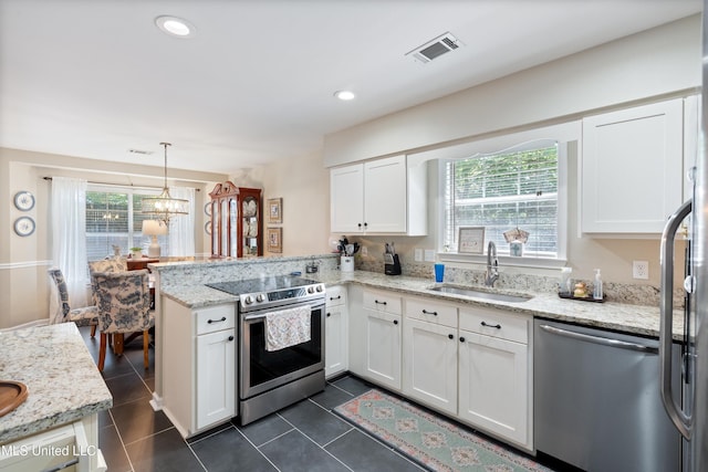 453 Cherry Tree Ln, Southaven, MS 38671 - kitchen with appliances with stainless steel finishes, a sink, a peninsula, white cabinetry, and dark tile patterned floors