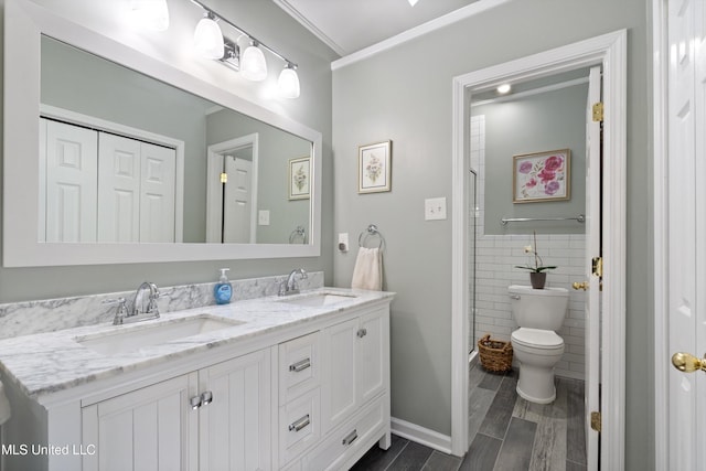 453 Cherry Tree Ln, Southaven, MS 38671 - bathroom featuring double vanity, toilet, a stall shower, ornamental molding, and tile walls