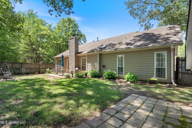 453 Cherry Tree Ln, Southaven, MS 38671 - back of property featuring a patio area and a chimney