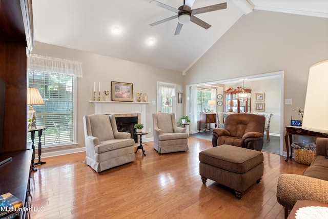 453 Cherry Tree Ln, Southaven, MS 38671 - living room featuring ceiling fan, wood-type flooring, beam ceiling, a tile fireplace, and high vaulted ceiling