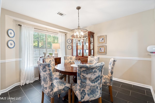 453 Cherry Tree Ln, Southaven, MS 38671 - dining area with a chandelier, dark tile patterned floors, and baseboards