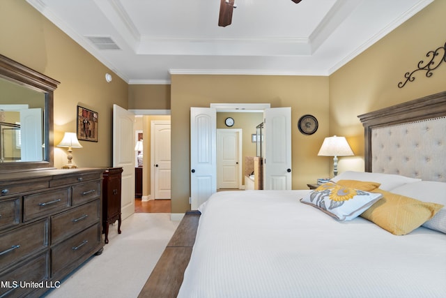 bedroom featuring light colored carpet, ceiling fan, crown molding, and a tray ceiling