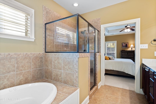 bathroom with tile patterned floors, vanity, separate shower and tub, and ceiling fan