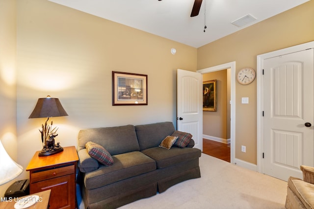 carpeted living room with ceiling fan