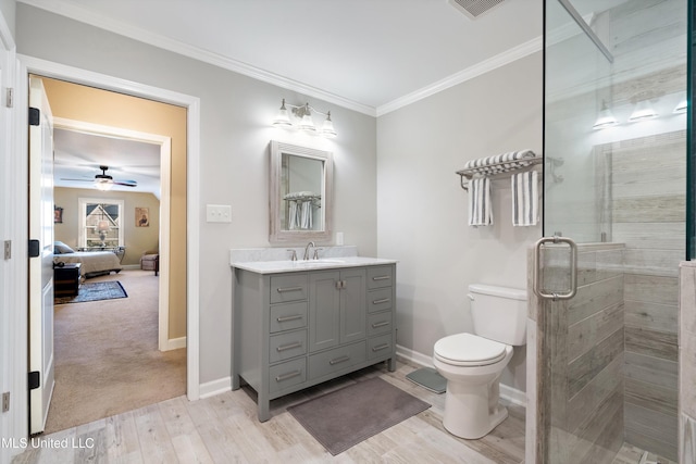 bathroom with an enclosed shower, ornamental molding, vanity, wood-type flooring, and toilet