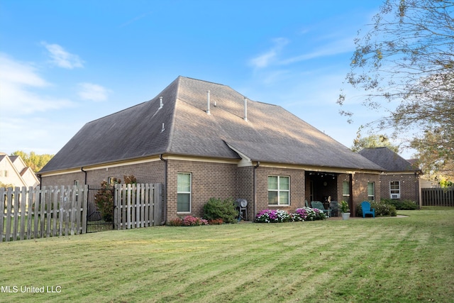 rear view of property with a yard