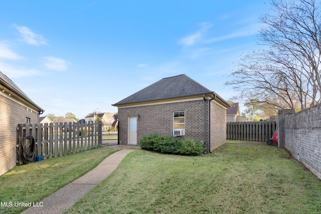 rear view of house featuring a yard and cooling unit