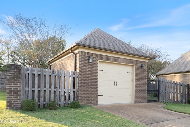 view of side of property with a yard, a garage, and an outdoor structure