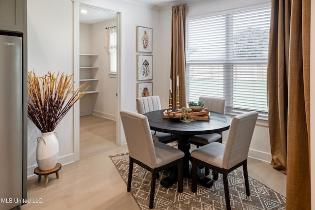 dining space with light hardwood / wood-style flooring