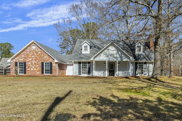 cape cod-style house with brick siding, a porch, and a front yard