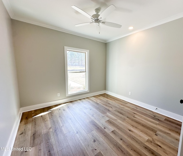 unfurnished room featuring light wood-style flooring, baseboards, ceiling fan, and crown molding