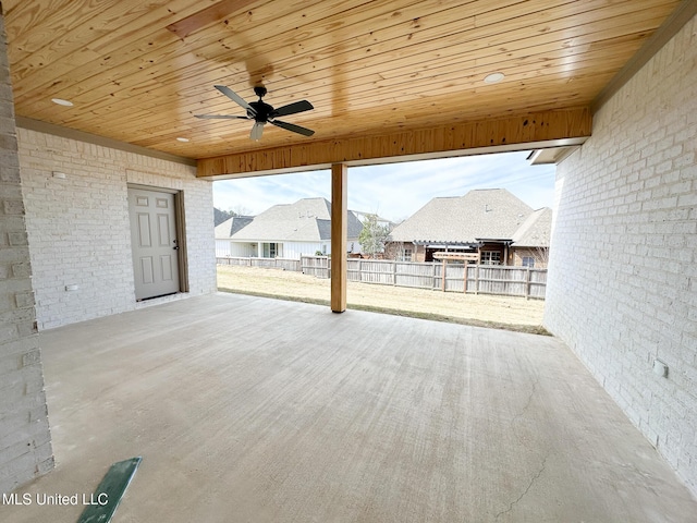 view of patio / terrace featuring ceiling fan, a residential view, and fence