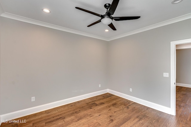 spare room with recessed lighting, crown molding, baseboards, and wood finished floors