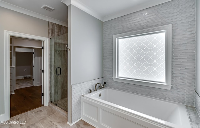 bathroom featuring ornamental molding, visible vents, a shower stall, and a bath