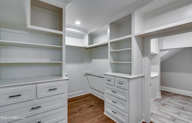 walk in closet featuring dark wood-style floors