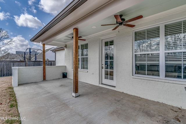 view of patio with a ceiling fan and fence