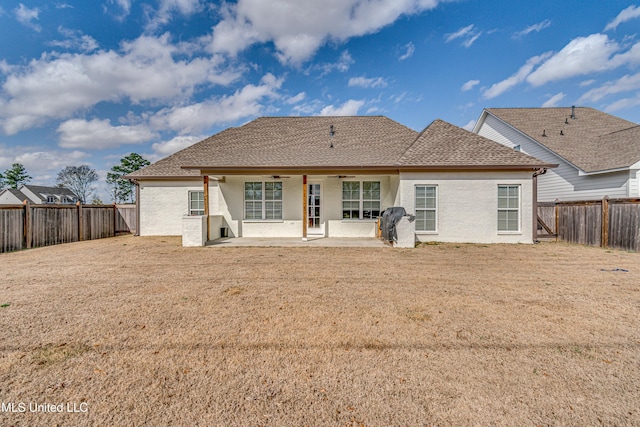 back of house featuring a patio area, ceiling fan, a lawn, and a fenced backyard