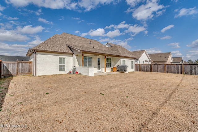 rear view of property with a patio area, a fenced backyard, a ceiling fan, and a shingled roof