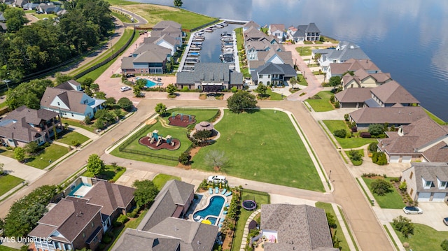 birds eye view of property with a residential view and a water view