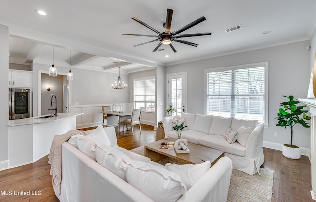 living area featuring visible vents, ornamental molding, beamed ceiling, wood finished floors, and recessed lighting