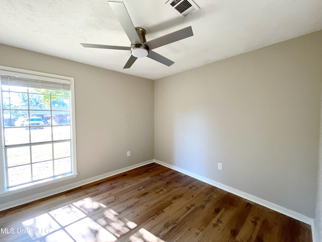 unfurnished room featuring hardwood / wood-style floors and ceiling fan