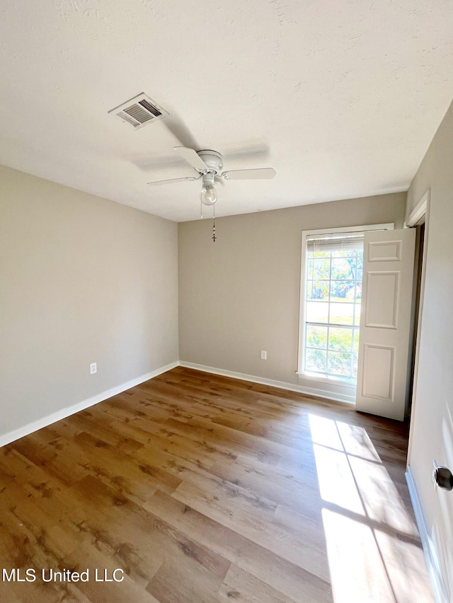 spare room featuring light hardwood / wood-style flooring and ceiling fan