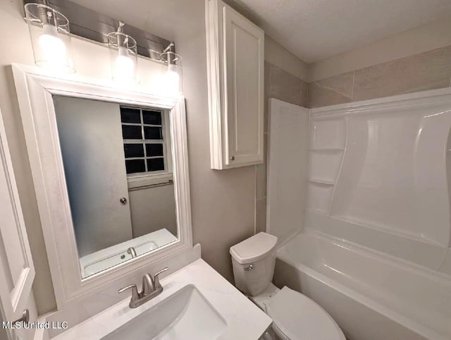 full bathroom with toilet, a textured ceiling, vanity, and bathing tub / shower combination