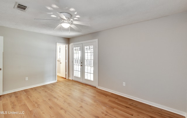 unfurnished room featuring french doors, ceiling fan, a textured ceiling, and light wood-type flooring