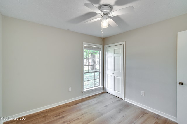 spare room featuring light hardwood / wood-style flooring, a textured ceiling, and ceiling fan