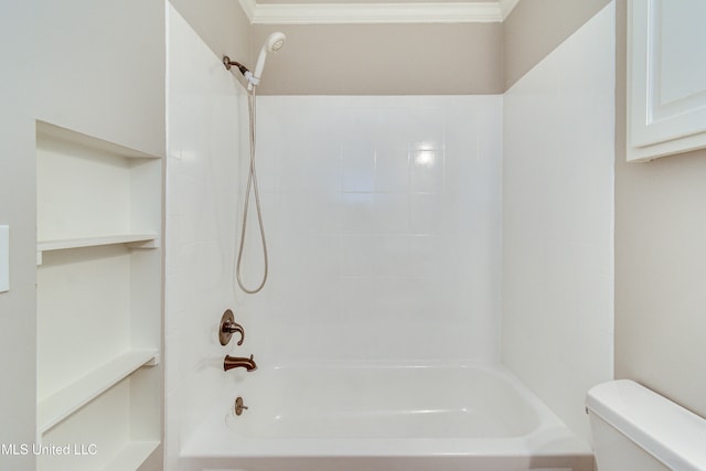 bathroom with tiled shower / bath, ornamental molding, and toilet